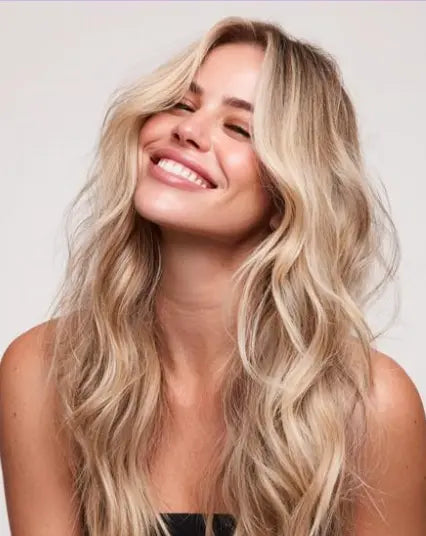 Professional Hair Styling Products in Bulk for Spas & Salons model showcasing beautiful, styled hair smiling.