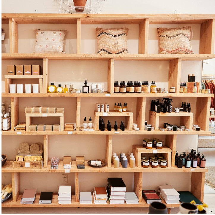 Wooden shelves with various products including bottles, boxes, and decorative items.