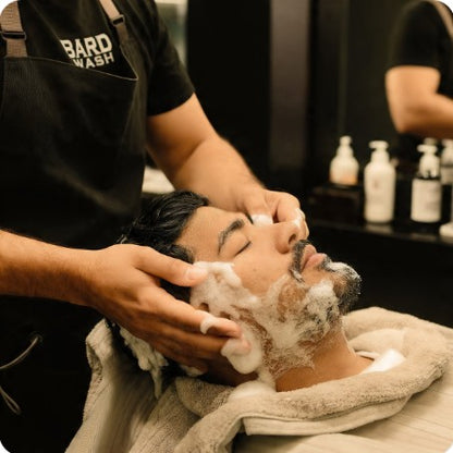 Person getting a facial wash treatment in a salon setting.