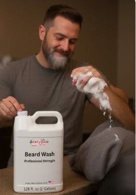 Man holding a bottle of beard wash with foam, sitting on a couch.