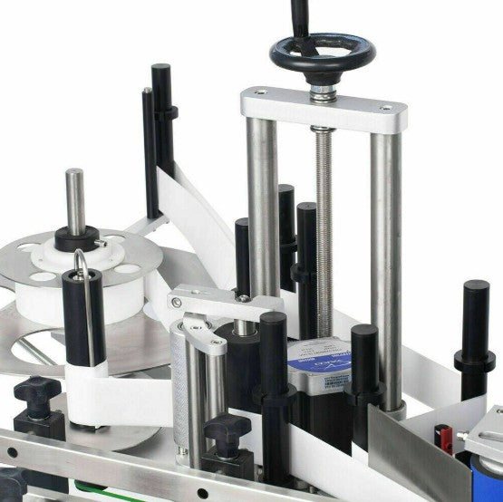 Close-up of a mechanical label applicator on a white background