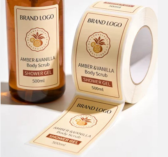 Roll of Amber & Vanilla Body Scrub shower gel labels on a white background