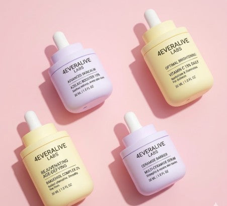 Four bottles of 4Everalive Labs skincare products on a pink background