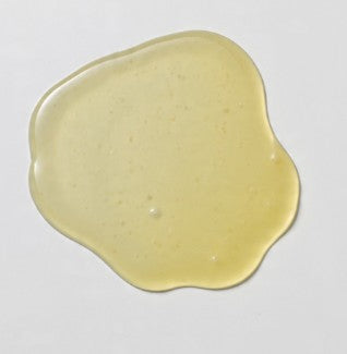 Yellow gel-like substance on a gray background